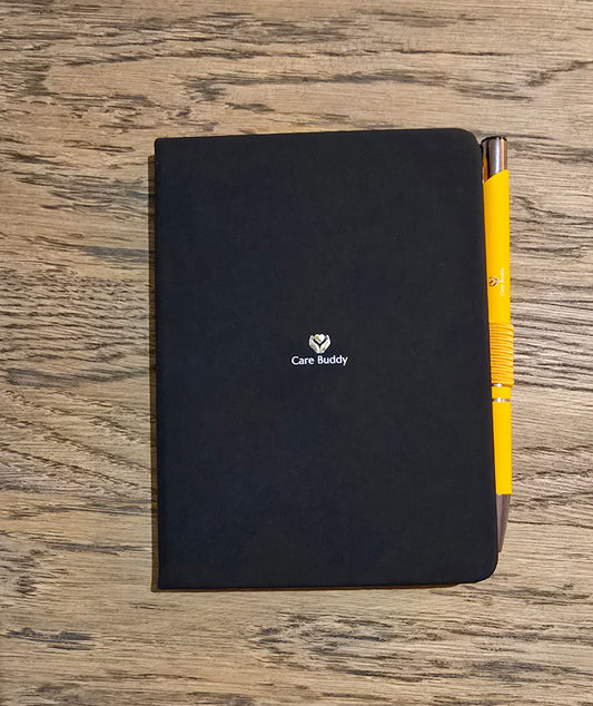 Care Buddy black Journal with a Carebuddy yellow pen in elasticataed holder for all your hospital notes and thoughts