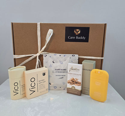 Care Buddy box with Vico natural Deodrant and Body Soap. Glow Mask. Butlers Choc bar. Haan Hydrating Sanitizer and Ground Wellbeing Face & Body oil