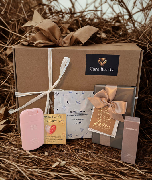 Care Buddy gift box with box of Butlers Chocolates, Glow mask, Pocket Heart, Hand Sanitizer and Ground Wellbeing Sleep Pillow Spray